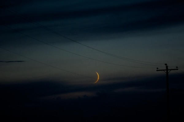 Waxing crescent moon and wires. Montana 